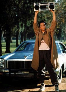 Lloyd Dobler wearing a trenchcoat in 'Say any such thing' keeping boombox floating around